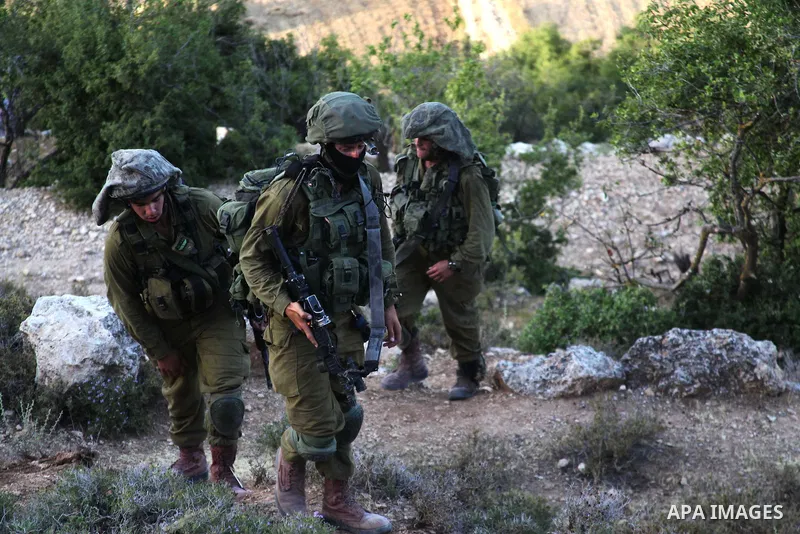 Israeli troops take part in a search operation on the outskirts of the West Bank town of Hebron on June 16,2014 as security forces broadened the search for three teenagers believed kidnapped by Palestinian militants and...