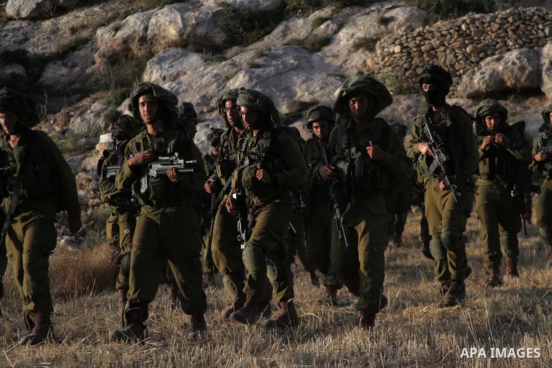 Israeli troops take part in a search operation on the outskirts of the West Bank town of Hebron on June 16,2014 as security forces broadened the search for three teenagers believed kidnapped by Palestinian militants and...