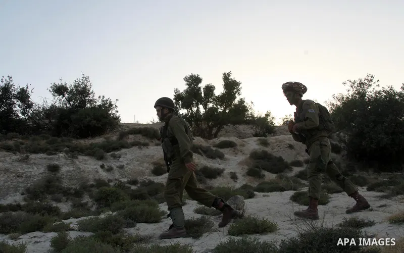 Israeli troops take part in a search operation on the outskirts of the West Bank town of Hebron on June 16,2014 as security forces broadened the search for three teenagers believed kidnapped by Palestinian militants and...
