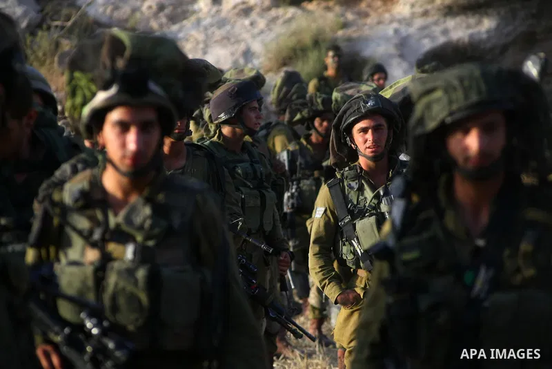 Israeli troops take part in a search operation on the outskirts of the West Bank town of Hebron on June 16,2014 as security forces broadened the search for three teenagers believed kidnapped by Palestinian militants and...