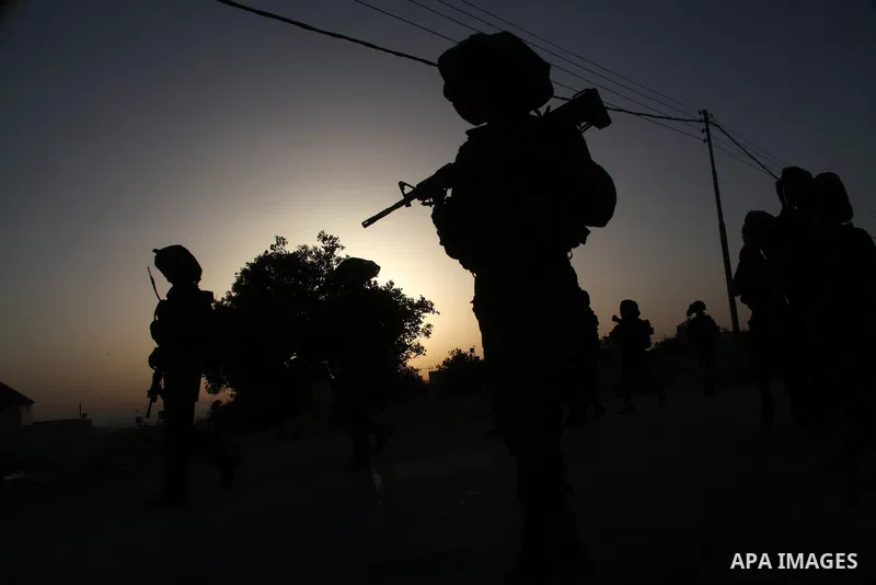 Israeli troops take part in a search operation on the outskirts of the West Bank town of Hebron on June 16,2014 as security forces broadened the search for three teenagers believed kidnapped by Palestinian militants and...