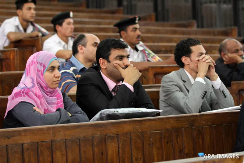 Egyptians attend the trial of Muslim Brotherhood members in the capital Cairo on June 17, 2014. The court postponed to July 23 the verdict in the trial of Muslim Brotherhood Supreme Guide Mohamed Badie and 50 others in t...