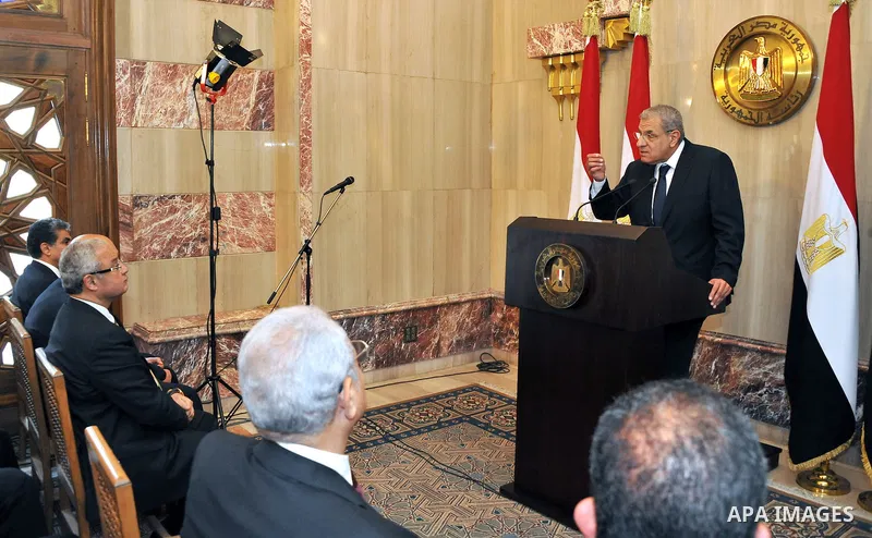 A handout picture released by Egyptian Presidency shows Egyptian Prime Minister Ibrahim Mahlab speaks to the ministers following a swearing-in ceremony for new cabinet ministers at the presidential palace in Cairo, June...