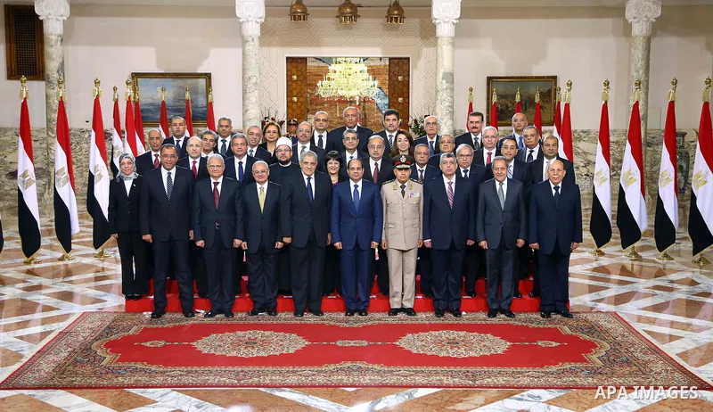 A handout picture released by Egyptian Presidency shows Egyptian President Abdel-Fattah el-Sissi, center, poses for a picture with the new ministers following a swearing-in ceremony for new cabinet ministers at the presi...
