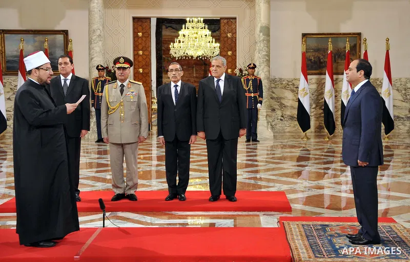 A handout picture released by Egyptian Presidency shows Egyptian President Abdel-Fattah el-Sissi, right, listens to the new ministers during a swearing-in ceremony for new cabinet ministers at the presidential palace in...