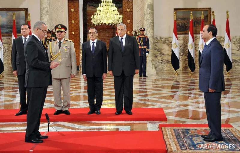 A handout picture released by Egyptian Presidency shows Egyptian President Abdel-Fattah el-Sissi, right, listens to the new ministers during a swearing-in ceremony for new cabinet ministers at the presidential palace in...