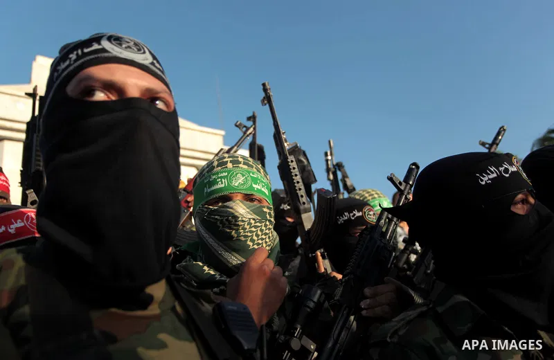 Palestinians militants from various armed factions, including Hamas, attend a news conference in Gaza City June 17, 2014. The news conference was held to protest against Israeli arrest of Palestinians in the West Bank as...