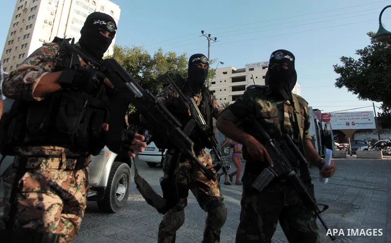 Palestinians militants from various armed factions, including Hamas, attend a news conference in Gaza City June 17, 2014. The news conference was held to protest against Israeli arrest of Palestinians in the West Bank as...