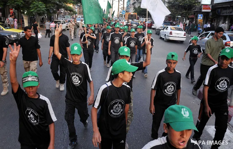 Palestinian children of the summer camps organized by Hamas movement, participate in a march to show solidarity with Palestinian prisoners held in Israeli jails, in Gaza City on June 18, 2014. Some 285 Palestinian prison...