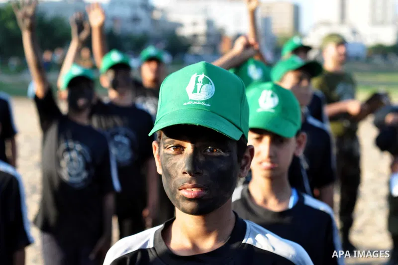 Palestinian youths take part in a military-style exercise at a summer camp organized by the Hamas movement in Gaza City June 18, 2014. Hamas stages dozens of military-style summer camps for young Palestinians in the Gaza...