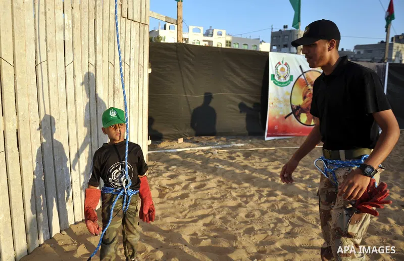 Palestinian youths take part in a military-style exercise at a summer camp organized by the Hamas movement in Gaza City June 18, 2014. Hamas stages dozens of military-style summer camps for young Palestinians in the Gaza...