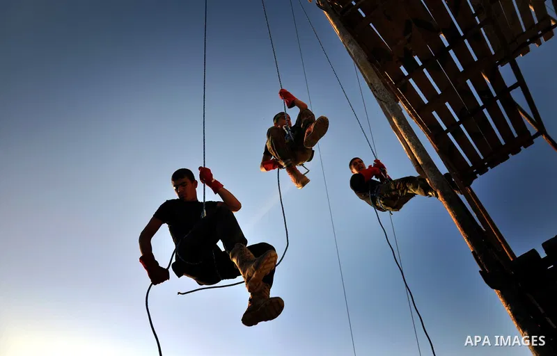 Palestinian youths take part in a military-style exercise at a summer camp organized by the Hamas movement in Gaza City June 18, 2014. Hamas stages dozens of military-style summer camps for young Palestinians in the Gaza...