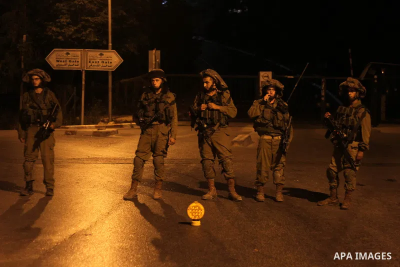 Israeli soldiers patrol at Birzeit University, on the outskirts of the city of Ramallah in the West Bank during an operation on June 19, 2014 as Israeli forces broadened the search for three teenagers believed kidnapped...
