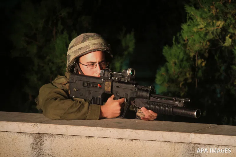 Israeli soldiers patrol at Birzeit University, on the outskirts of the city of Ramallah in the West Bank during an operation on June 19, 2014 as Israeli forces broadened the search for three teenagers believed kidnapped...