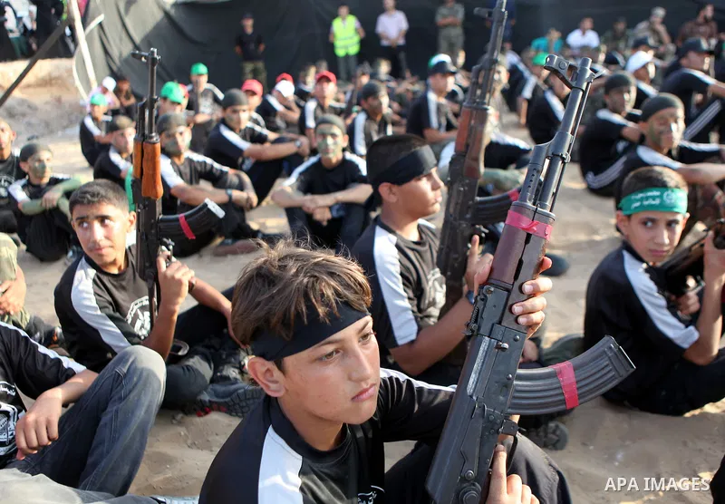 Palestinian youths take part in a graduation ceremony of a military-style summer camp organized by the Hamas movement in Gaza City June 19, 2014. Hamas stages dozens of military-style summer camps for young Palestinians...