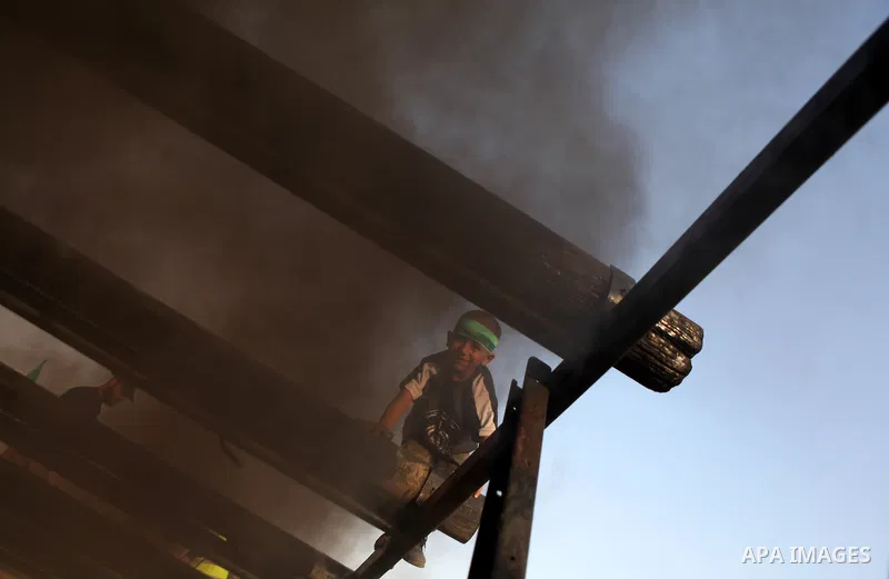 A Palestinian youth demonstrates his skills during a graduation ceremony of a military-style summer camp organized by the Hamas movement in Gaza City June 19, 2014. Hamas stages dozens of military-style summer camps for...