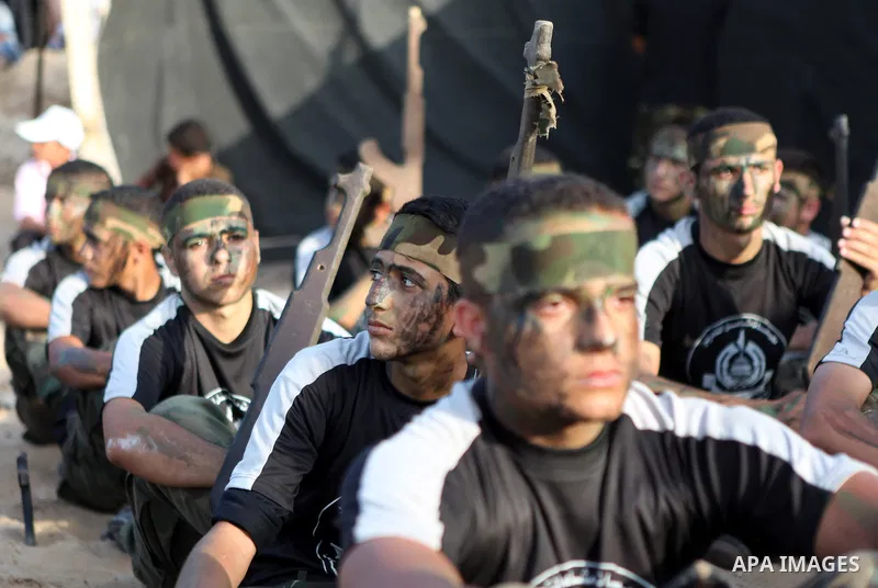 Palestinian youths take part in a graduation ceremony of a military-style summer camp organized by the Hamas movement in Gaza City June 19, 2014. Hamas stages dozens of military-style summer camps for young Palestinians...
