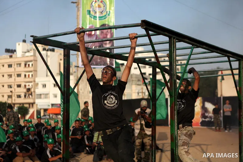Palestinian youths demonstrate their skills during a graduation ceremony of a military-style summer camp organized by the Hamas movement in Gaza City June 19, 2014. Hamas stages dozens of military-style summer camps for...