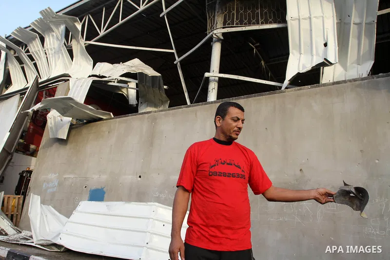 A Palestinian man inspects a food store following an Israeli air-strike in Gaza City on June 20, 2014. The Israeli army’s air force has conducted several air raids on the besieged Gaza Strip, leaving at least seven Pales...