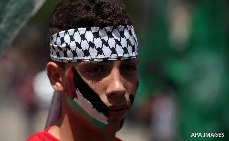 Palestinian Hamas supporters take part in a demonstration in solidarity with prisoners held in Israeli jails, and in support of the people in the West Bank, in Nuseirat refugee camp in the center of the Gaza Strip, June...