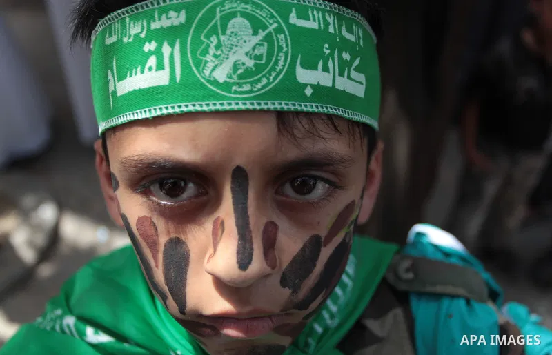 Palestinian Hamas supporters take part in a demonstration in solidarity with prisoners held in Israeli jails, and in support of the people in the West Bank, in Nuseirat refugee camp in the center of the Gaza Strip, June...