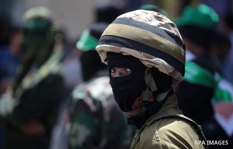 Palestinian Hamas militants take part in a demonstration in solidarity with prisoners held in Israeli jails, and in support of the people in the West Bank, in Nuseirat refugee camp in the center of the Gaza Strip, June 2...