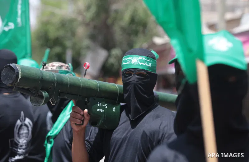 Palestinian Hamas militants take part in a demonstration in solidarity with prisoners held in Israeli jails, and in support of the people in the West Bank, in Nuseirat refugee camp in the center of the Gaza Strip, June 2...