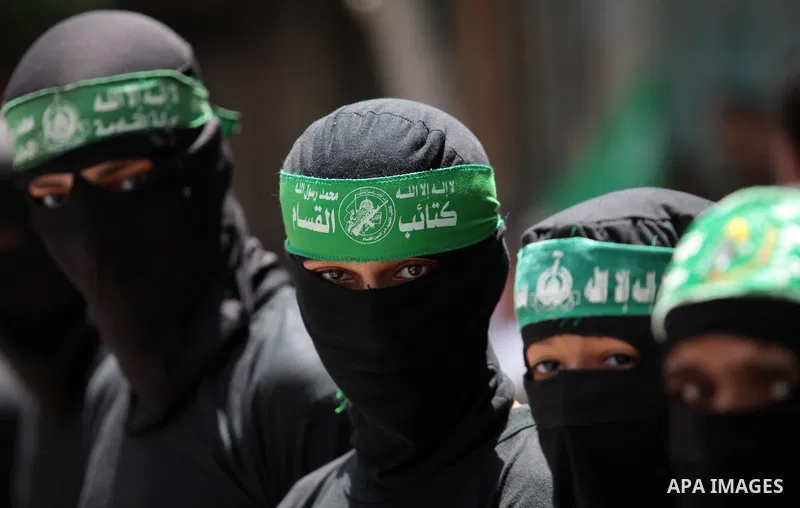 Palestinian Hamas militants take part in a demonstration in solidarity with prisoners held in Israeli jails, and in support of the people in the West Bank, in Nuseirat refugee camp in the center of the Gaza Strip, June 2...