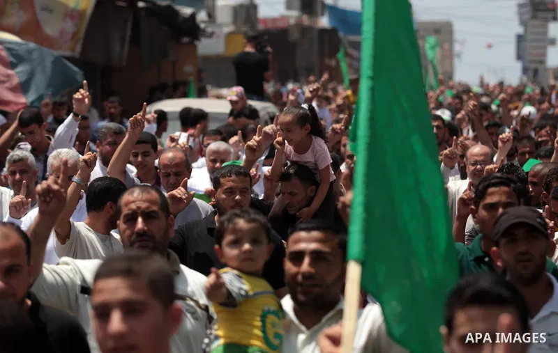 Palestinian Hamas supporters take part in a demonstration in solidarity with prisoners held in Israeli jails, and in support of the people in the West Bank, in Nuseirat refugee camp in the center of the Gaza Strip, June...