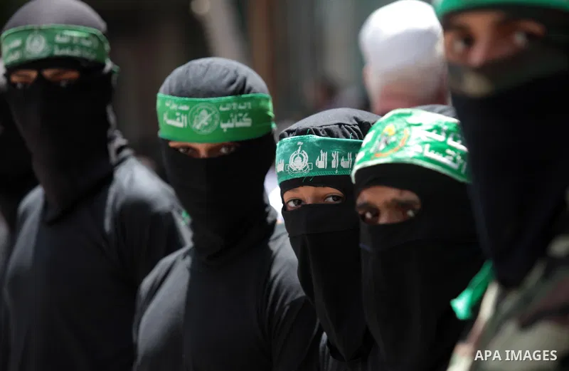 Palestinian Hamas militants take part in a demonstration in solidarity with prisoners held in Israeli jails, and in support of the people in the West Bank, in Nuseirat refugee camp in the center of the Gaza Strip, June 2...