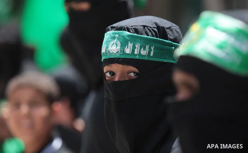 Palestinian Hamas militants take part in a demonstration in solidarity with prisoners held in Israeli jails, and in support of the people in the West Bank, in Nuseirat refugee camp in the center of the Gaza Strip, June 2...