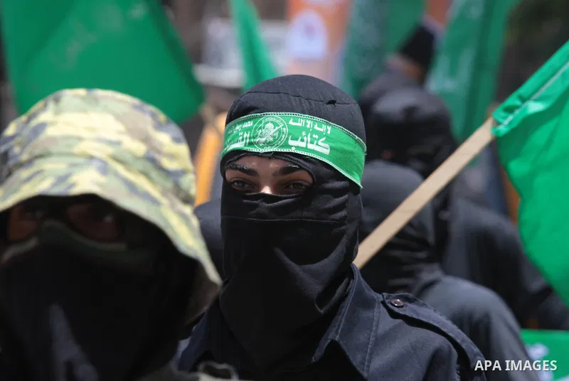 Palestinian Hamas militants take part in a demonstration in solidarity with prisoners held in Israeli jails, and in support of the people in the West Bank, in Nuseirat refugee camp in the center of the Gaza Strip, June 2...