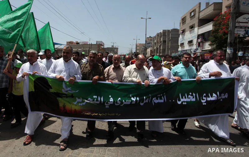Palestinian Hamas supporters take part in a demonstration in solidarity with prisoners held in Israeli jails, and in support of the people in the West Bank, in Nuseirat refugee camp in the center of the Gaza Strip, June...