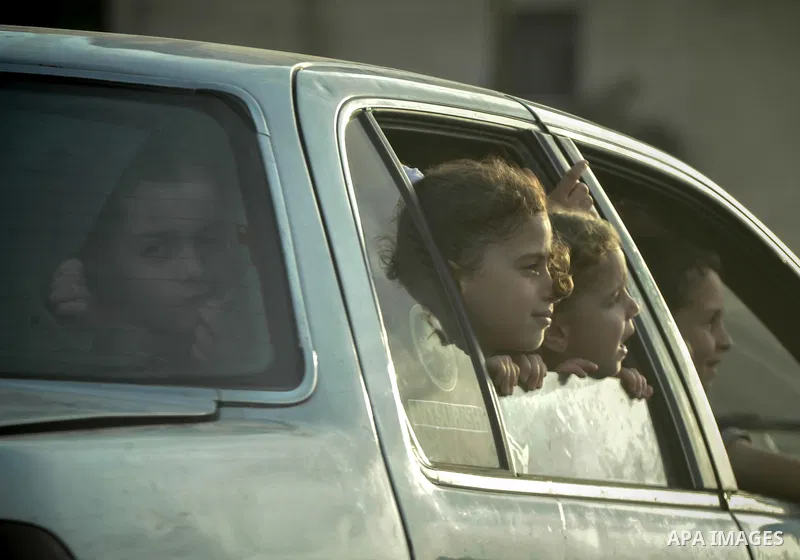 Palestinian children look through car window on the beach of Gaza City June 20, 2014. Photo by Ezz al-Zanoun
