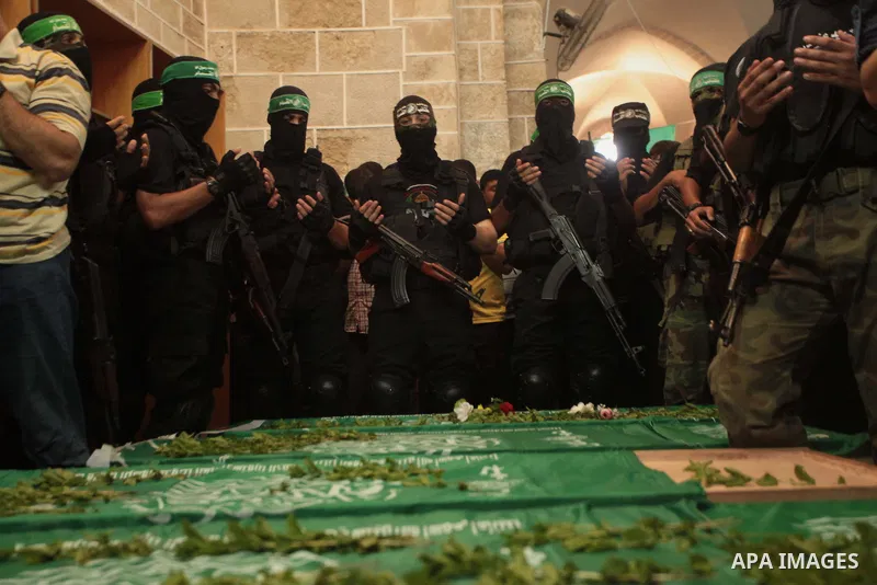 Mourners surround the bodies of Palestinian members of Hamas' armed wing during their funeral at a mosque in Gaza City June 21, 2014. Hamas' armed wing in Gaza said at least six members of its group were killed in the co...