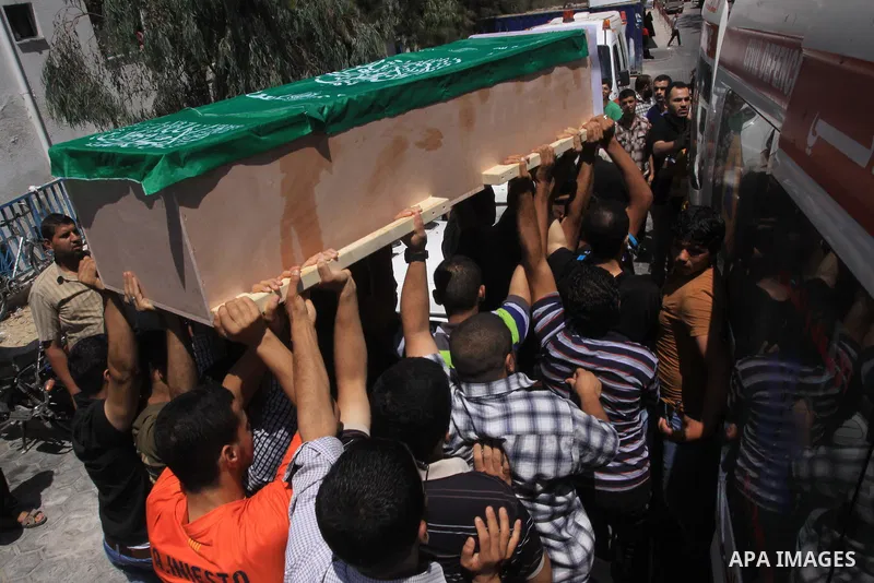 Palestinians carry a coffin as they attend the funeral of Palestinian who died two days ago after an explosion caused the collapse of a tunnel under the Israeli border, on June 21, 2014, in Gaza City. In addition to tunn...