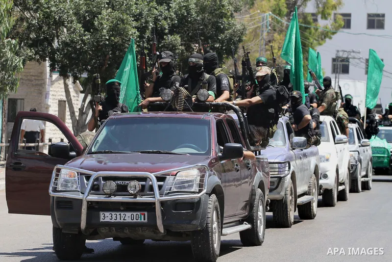 Palestinian members of the Ezzedine al-Qassam Brigades, the military wing of Hamas, attend the funeral of comrades who died two days ago after an explosion caused the collapse of a tunnel under the Israeli border, on Jun...