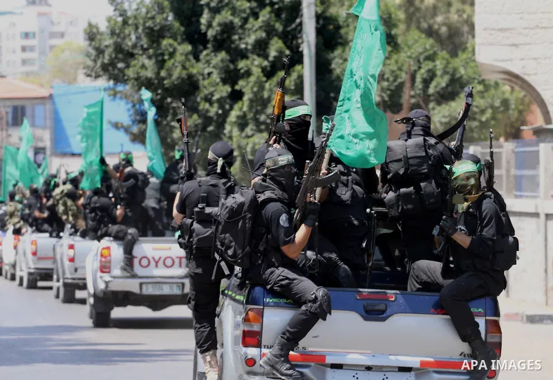 Palestinian members of the Ezzedine al-Qassam Brigades, the military wing of Hamas, attend the funeral of comrades who died two days ago after an explosion caused the collapse of a tunnel under the Israeli border, on Jun...