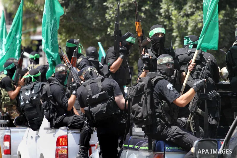 Palestinian members of the Ezzedine al-Qassam Brigades, the military wing of Hamas, attend the funeral of comrades who died two days ago after an explosion caused the collapse of a tunnel under the Israeli border, on Jun...