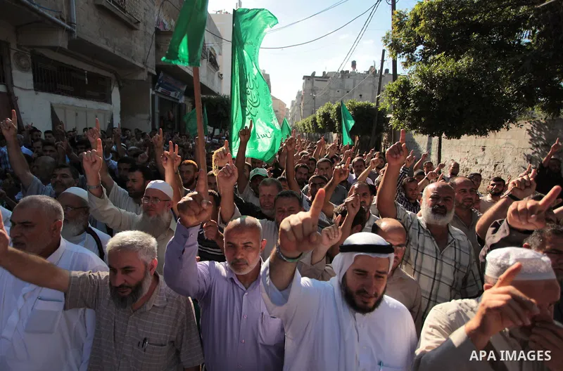 Palestinian Hamas supporters take part in a rally in solidarity with the hunger-striking Palestinian prisoners held by Israel, in Jabalia refugee camp in the northern Gaza Strip, June 24, 2014. Nearly 300 Palestinian pri...