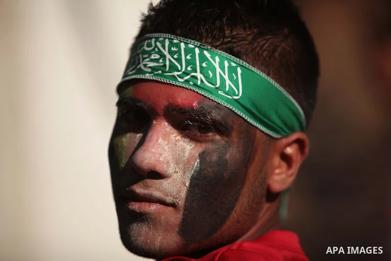 A Palestinian boy poses as he takes part in a rally in solidarity with the hunger-striking Palestinian prisoners held by Israel, in Jabalia refugee camp in the northern Gaza Strip, June 24, 2014. Nearly 300 Palestinian p...
