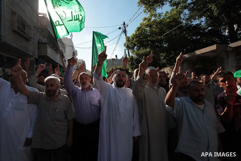 Palestinian Hamas supporters take part in a rally in solidarity with the hunger-striking Palestinian prisoners held by Israel, in Jabalia refugee camp in the northern Gaza Strip, June 24, 2014. Nearly 300 Palestinian pri...