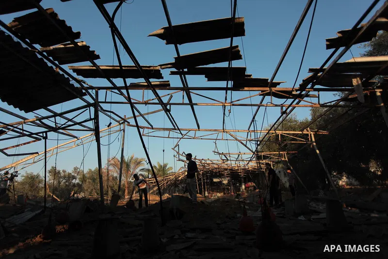 Palestinian men inspect a chicken coop damaged in an Israeli air strike in Khan Younis in the southern Gaza Strip June 25, 2014. Militants in the Gaza Strip, a coastal enclave where Hamas is dominant and has vowed reveng...