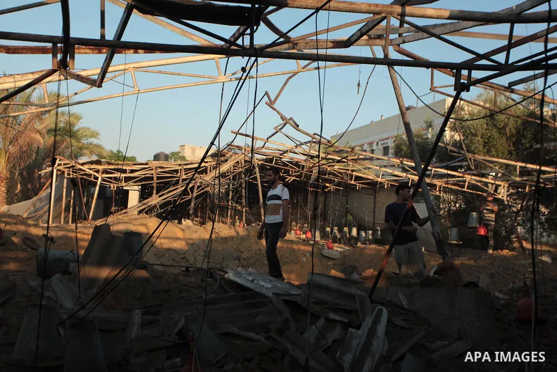 Palestinian men inspect a chicken coop damaged in an Israeli air strike in Khan Younis in the southern Gaza Strip June 25, 2014. Militants in the Gaza Strip, a coastal enclave where Hamas is dominant and has vowed reveng...