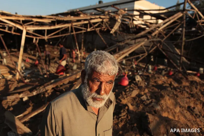 Palestinian men inspect a chicken coop damaged in an Israeli air strike in Khan Younis in the southern Gaza Strip June 25, 2014. Militants in the Gaza Strip, a coastal enclave where Hamas is dominant and has vowed reveng...