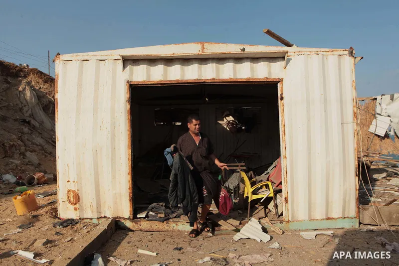 A Palestinian man inspects the site of an Israeli air strike in the central Gaza Strip June 25, 2014. Militants in the Gaza Strip, a coastal enclave where Hamas is dominant and has vowed revenge at Israel's crackdown, fi...
