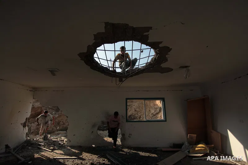 Palestinian men inspect the site of an Israeli air strike in the central Gaza Strip June 25, 2014. Militants in the Gaza Strip, a coastal enclave where Hamas is dominant and has vowed revenge at Israel's crackdown, fired...
