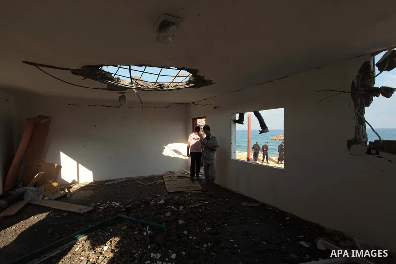 Palestinian men inspect the site of an Israeli air strike in the central Gaza Strip June 25, 2014. Militants in the Gaza Strip, a coastal enclave where Hamas is dominant and has vowed revenge at Israel's crackdown, fired...