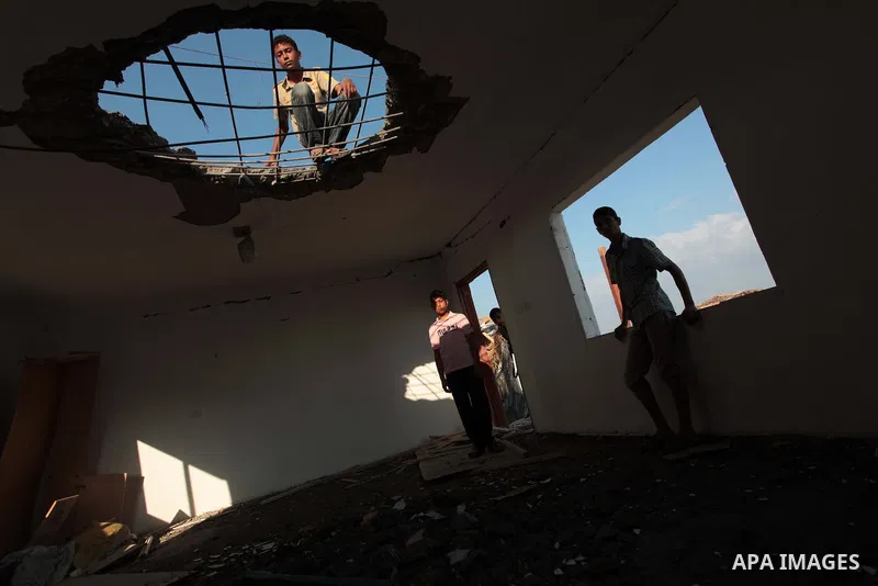 Palestinian men inspect the site of an Israeli air strike in the central Gaza Strip June 25, 2014. Militants in the Gaza Strip, a coastal enclave where Hamas is dominant and has vowed revenge at Israel's crackdown, fired...