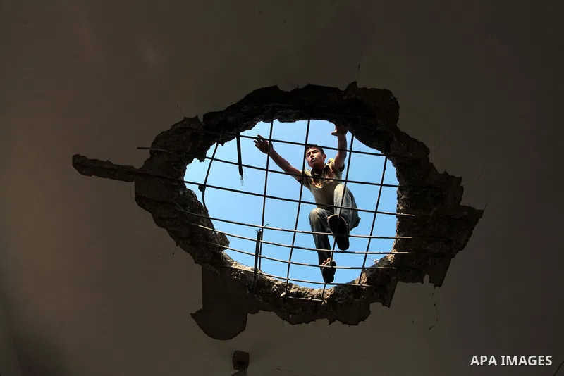 A Palestinian man inspects the site of an Israeli air strike in the central Gaza Strip June 25, 2014. Militants in the Gaza Strip, a coastal enclave where Hamas is dominant and has vowed revenge at Israel's crackdown, fi...